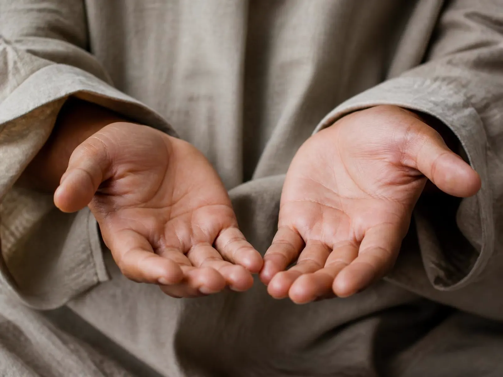 Two open hands resting palm-up in soft daylight